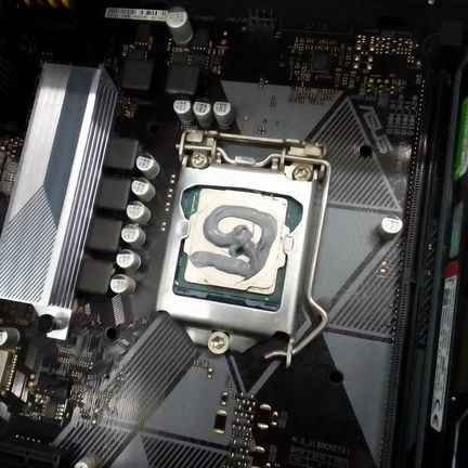 The interior of my PC with its CPU getting its new thermal paste